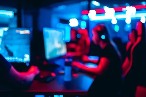 Player resting head on the desk in a warm coat during a long night at the computer club
